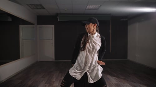 Woman Dances with Style in Urban Studio