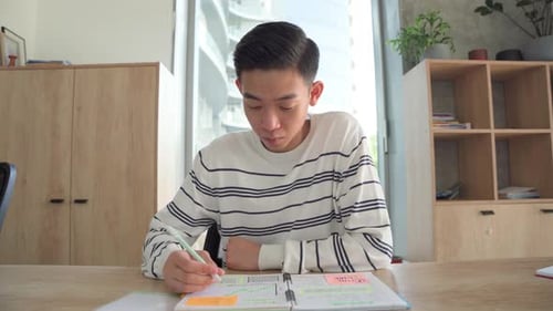 Young Asian Student Has Online Class Video Call in Classroom