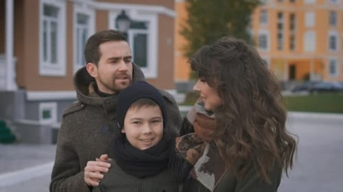Happy Family on a Photo Shoot. Mother, Father and Son. They Pose for the Camera. The Family Has an
