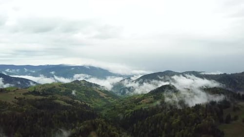 Aerial View of Green Mountain Landscape with Mist
