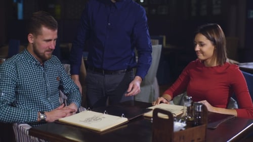 the Waiter Takes Your Order at the Beautiful Couple in the Restaurant