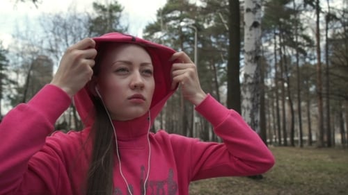 Beautiful Girl with Long Hairs Puts the Hood