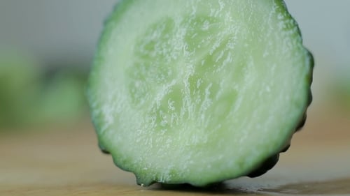 Fresh Green Cucumber Sliced on Wooden Surface