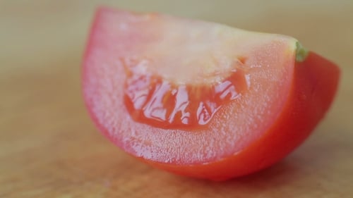 Knife Slicing a Fresh, Juicy Tomato