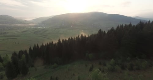 Aerial View of Rolling Green Hills at Sunrise
