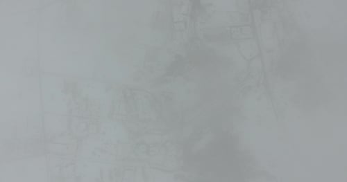 Because of the Clouds Seen a Snowy Town. Aerial View