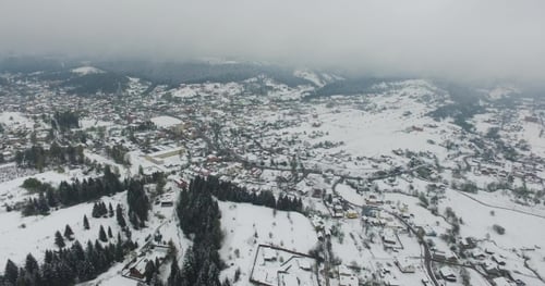 Winter. Flying Over the Village in the Hills of Valley