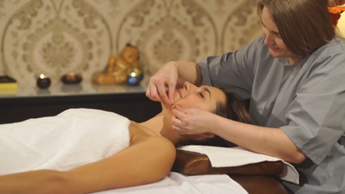 Woman receiving facial massage for relaxation and beauty