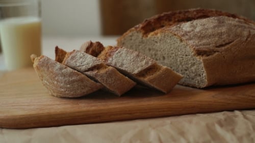 Fresh Bread and Milk on Wooden Cutting Board