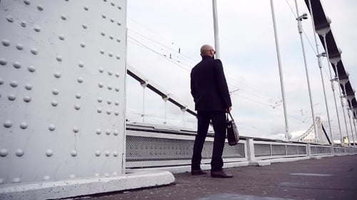 Young Businessman Walking Down a Sidewalk, . Man Walking on the Street in the City, Steadycam Shot.