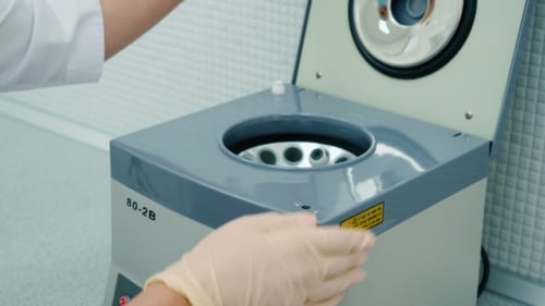 Doctor Take a Tube with Blood From the Centrifuge