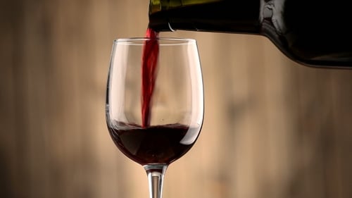 Pouring Red Wine into a Glass
