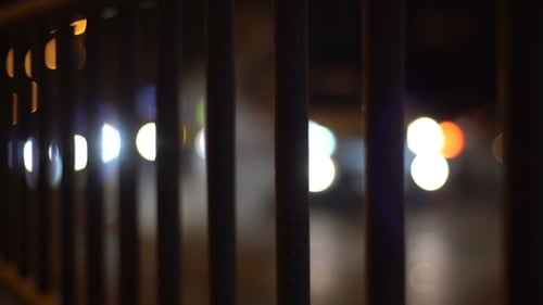 Street Traffic Behind Metal Fence
