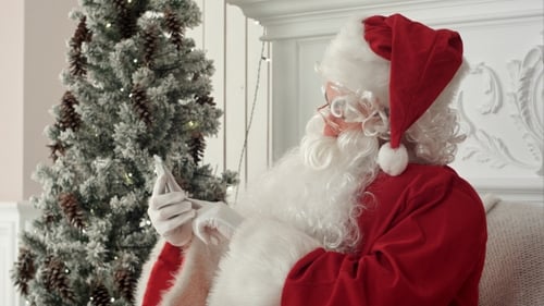 Laughing Santa Claus Reading Christmas Messages From Kids