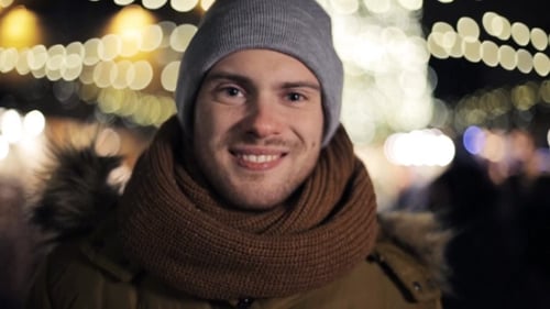 Smiling Man Outside in Winter Clothing at Night
