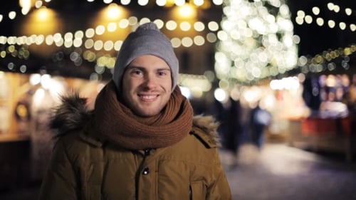 Man Smiling Wearing Winter Clothing at Night