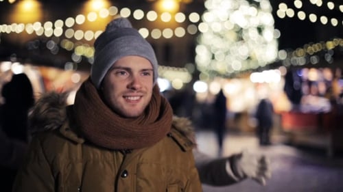 Playful Couple Celebrating Winter Holidays at Night