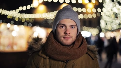 Smiling Man at Night in a Christmas Market