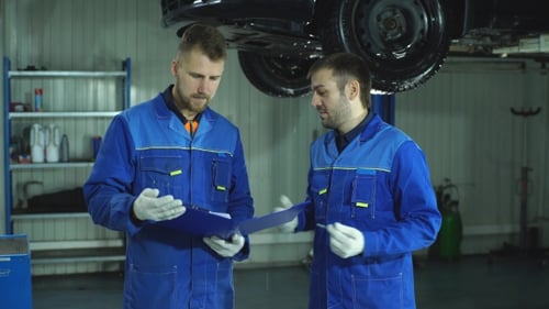 Mechanics Conferring in Auto Repair Shop