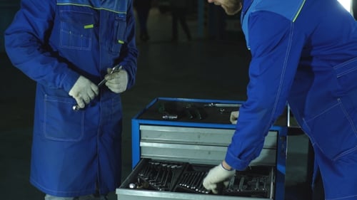 Auto Mechanic with Working Tools For Repair and Diagnostics of Cars in the Garage Car