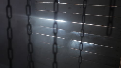 Eerie Dungeon with Hanging Chains and Smoke