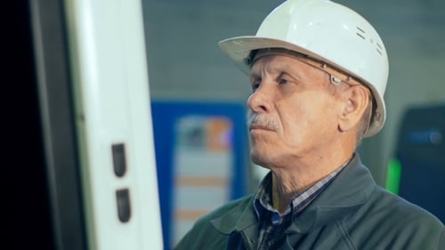 Worker at Workshop Operating Industrial Machine By Computer