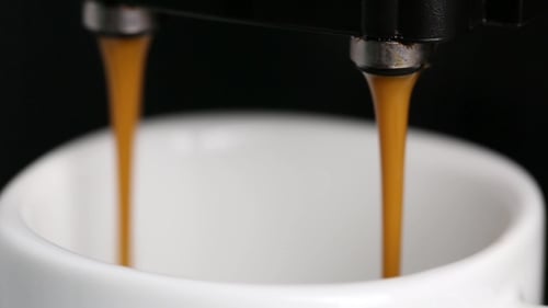 Espresso Pouring Into Mug from Coffee Machine