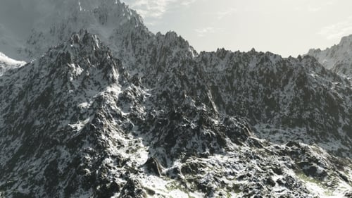 Mountains in Snow and Clouds at Blue Sky