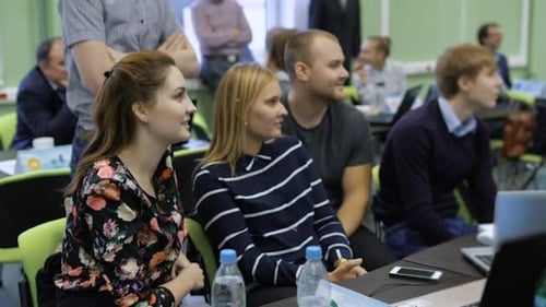 Young Adults Attending a Presentation in Classroom