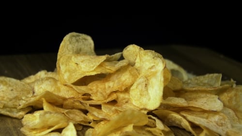 Potato Chips Rotating On Black Background