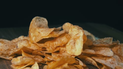 Potato Chips Rotating On Black Background