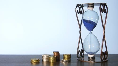 Clock And Stacks Of Coins