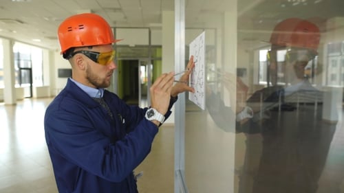 Architect Builder Studying Layout Plan of the Rooms, Serious Civil Engineer Working with Documents