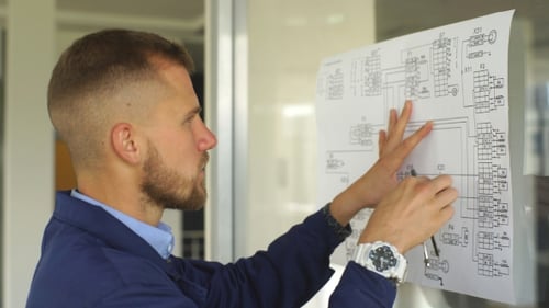 Architect Builder Studying Layout Plan of the Rooms, Serious Civil Engineer Working with Documents