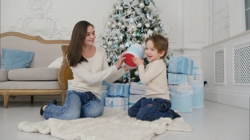 Mother and Child Playing with Gifts at Christmas