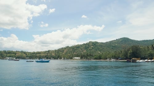 Several Small Boats Moored Close To the Beautiful Tropical Island. Large Bay with Clear Blue Water