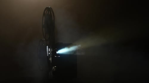Vintage Film Projector Illuminates Dark Room with Light