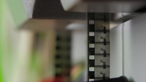 Close up of Vintage Filmstrip Moving Through Projector