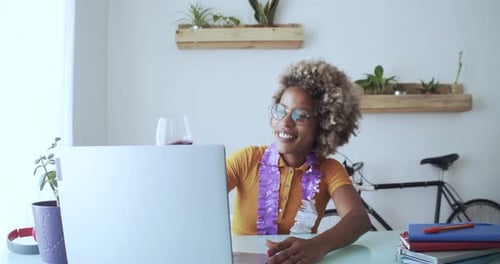 Woman Toasting Wine on Laptop Video Call at Home