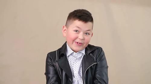 Happy Young Boy Smiling and Gesturing Indoors