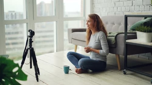 Young Woman Creates Vlog in Urban Apartment