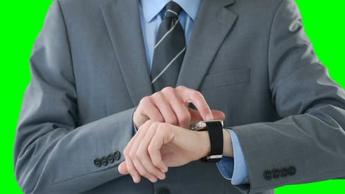 Mid-section of businessman using smartwatch