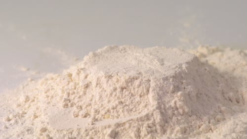 Eggs being poured onto flour for baking