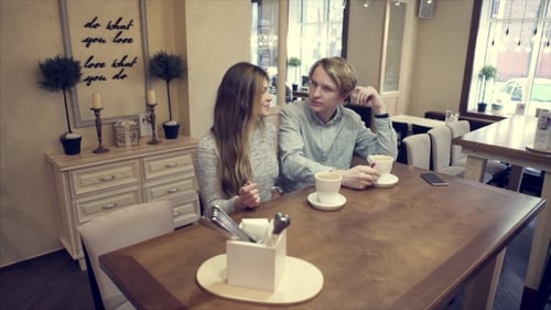 Student Couple Chatting Together in a Cafe