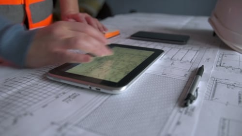 Architectural Drawings and Tablet in the Workplace
