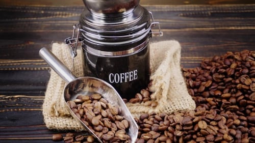 Coffee Beans in Scoop by Coffee Jar