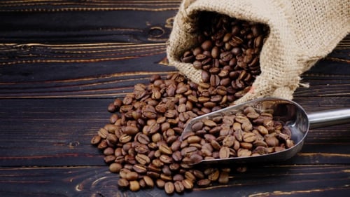 Roasted Coffee Beans Spilled with Scoop and Burlap