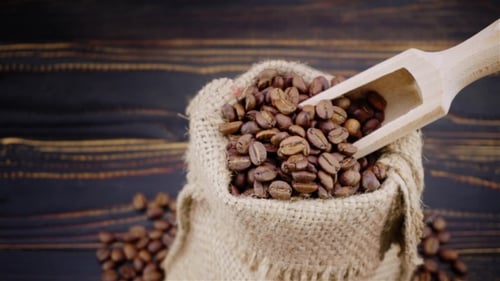 Roasted Coffee Beans in Burlap Sack with Scoop