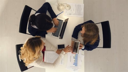 Young Business Woman Group Working on Tablet Computer and Laptop in the Office