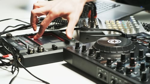 Disc Jockey's Hands While He Changes Settings of the Sound Control System